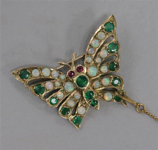 A gold, emerald and opal butterfly brooch 3.5cm.